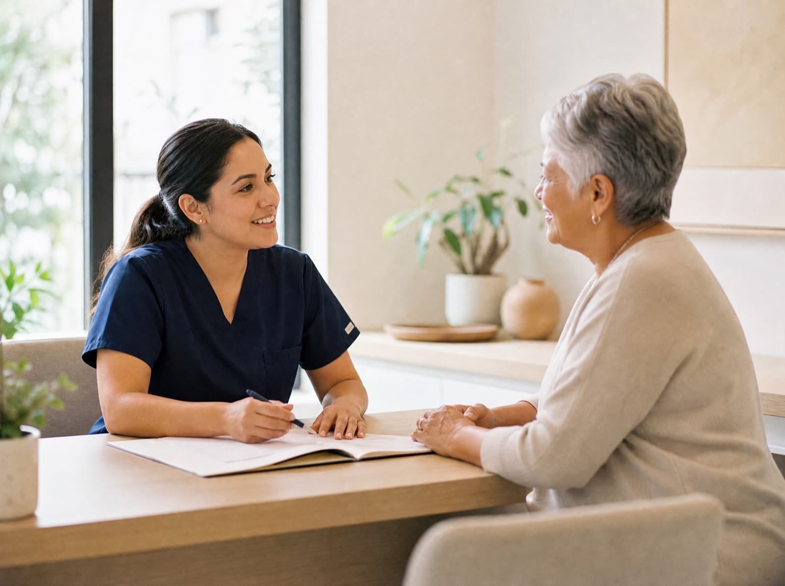A Soza Clinic practitioner and a patient talking across a desk at the Richardson clinic